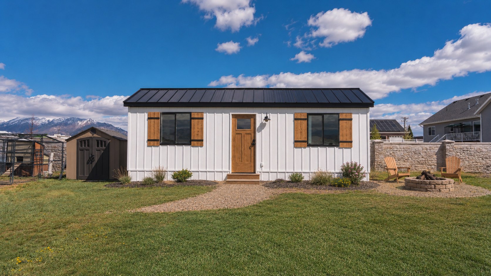 A finished Cocoon backyard ADU in Utah with board-and-batten siding, cedar shutters, and a firepit seating area