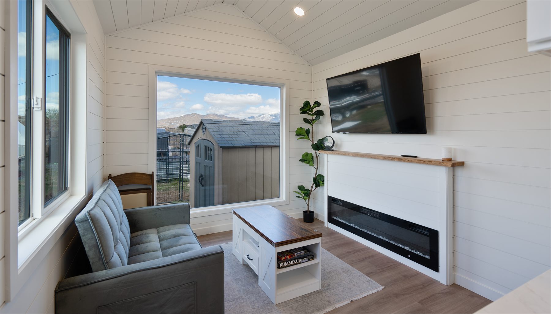Cocoon ADU living room with shiplap walls and a modern fireplace